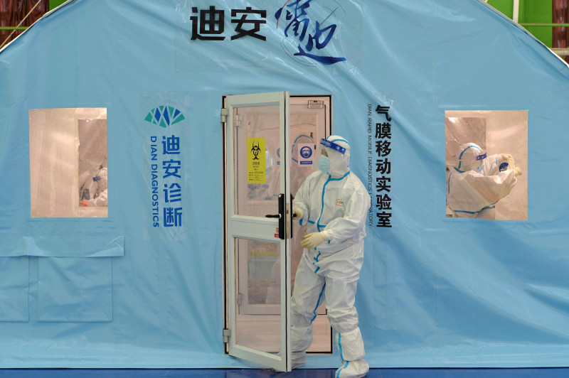 عامل صحي يخرج من مختبر ديان للتشخيص المتنقل السريع في تيانجين. الصين